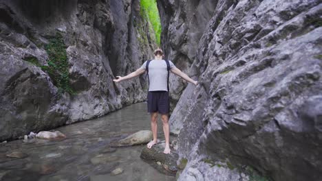 Free-and-peaceful-young-man-in-the-creek-in-the-canyon.